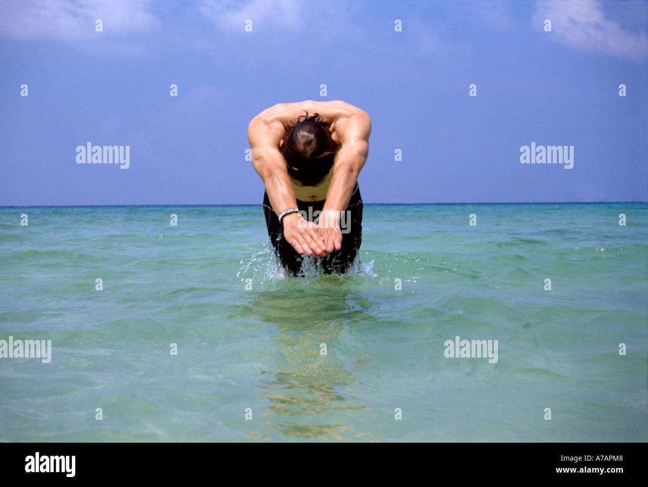 Jeune homme de plonger dans l'océan tropical Banque D'Images