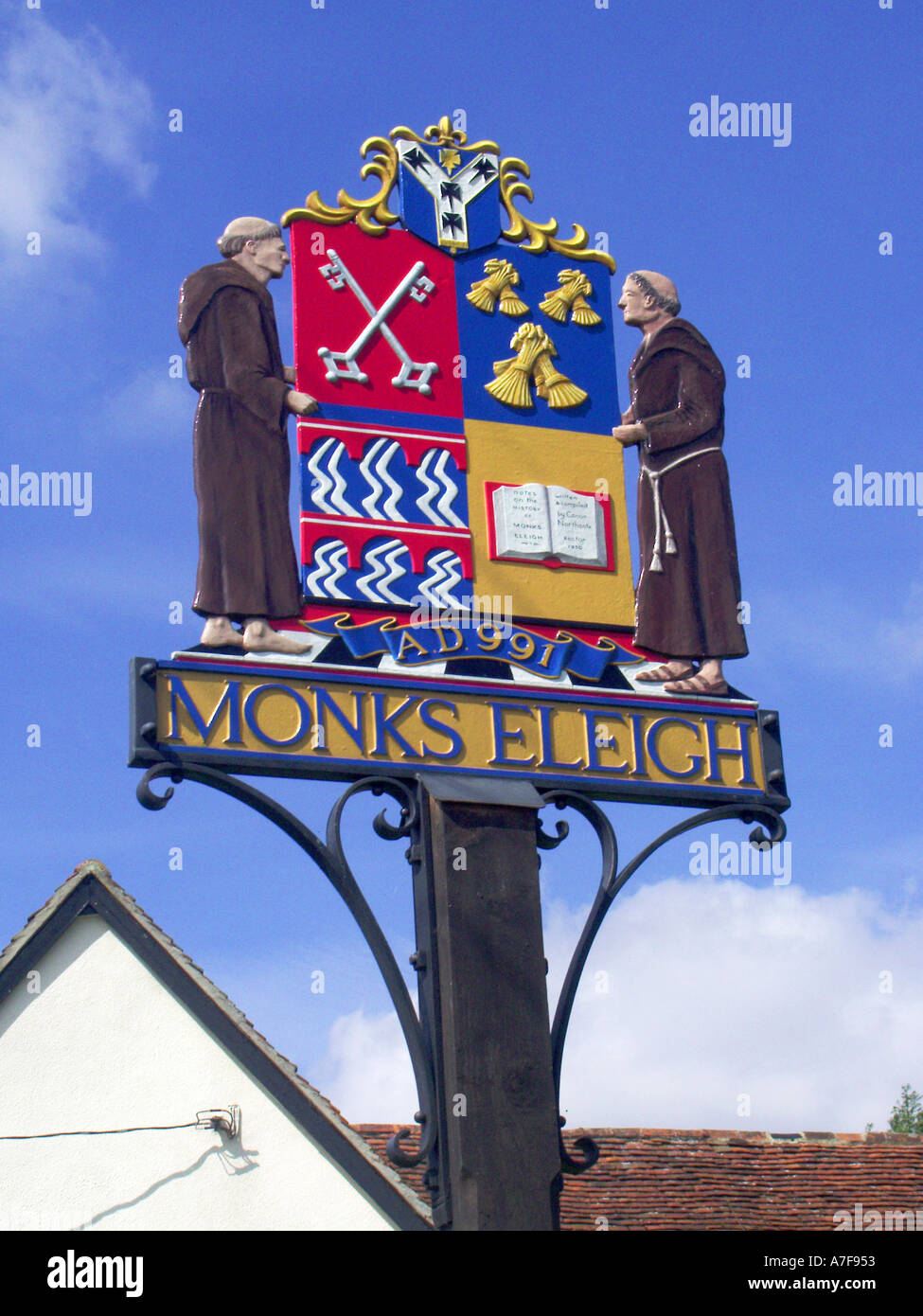 Monks in Milden close up of village coloré signe représentant des figures et des caractéristiques associées à la région de l'East Anglia Suffolk Angleterre UK Banque D'Images