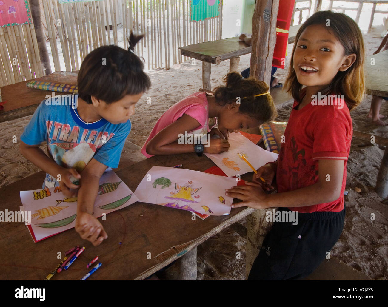 Filles Moken sea gypsy de rendre l'art à l'école sur Ko Surin île thaïlandaise dans le Parc National de Mu Koh Surin LA MER D'Andaman en Thaïlande Banque D'Images