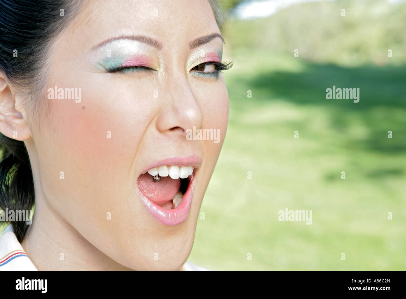 Close-up of a young woman winking Banque D'Images