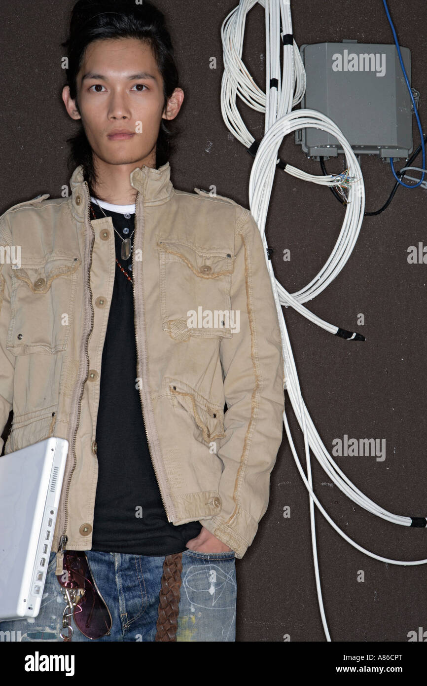 Young man holding laptop, portrait Banque D'Images