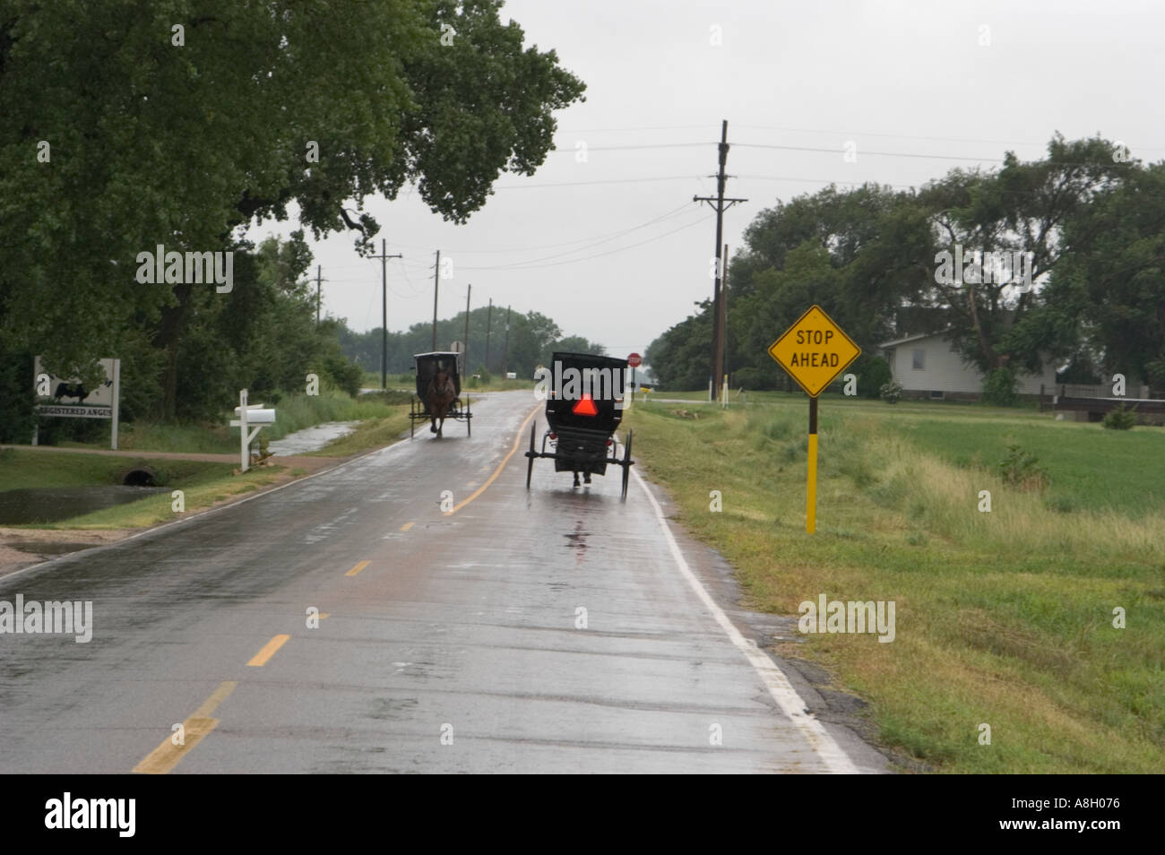 Voitures Amish sur route lissés pluie Yoder Kansas Banque D'Images