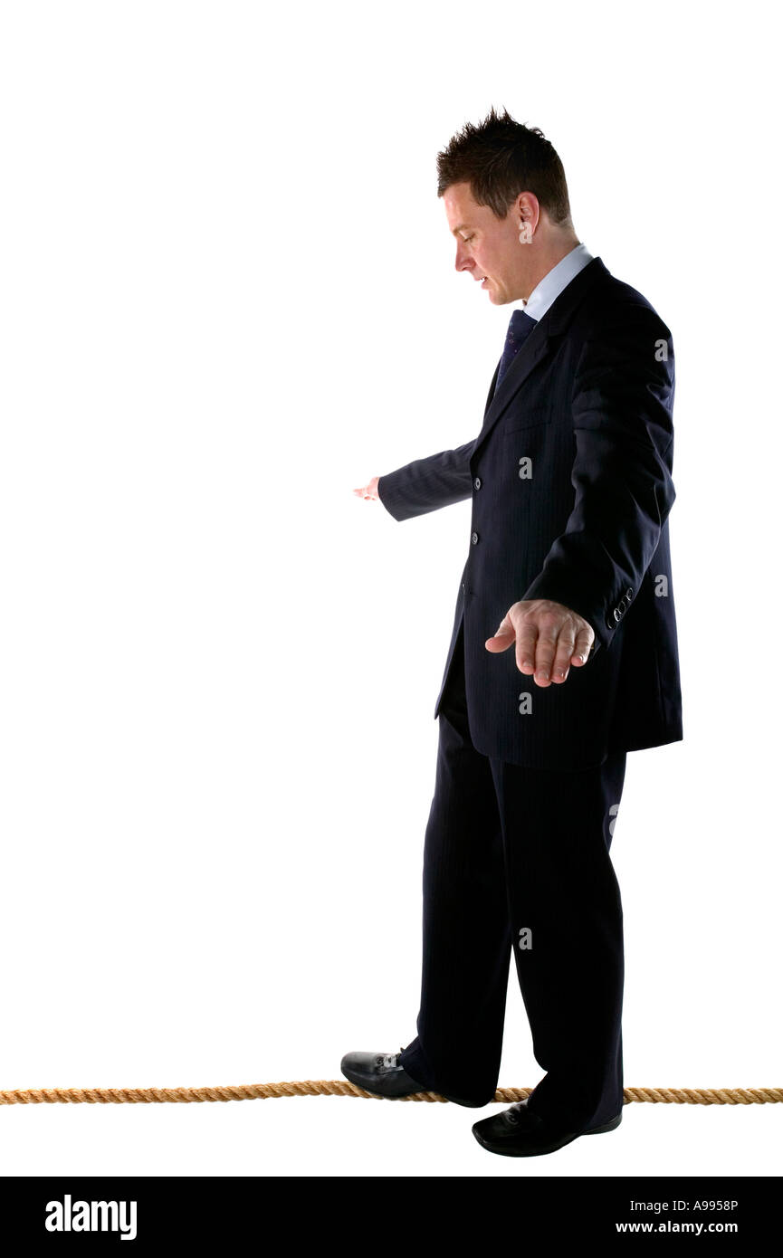 Businessman walking un fil isolé sur blanc Banque D'Images