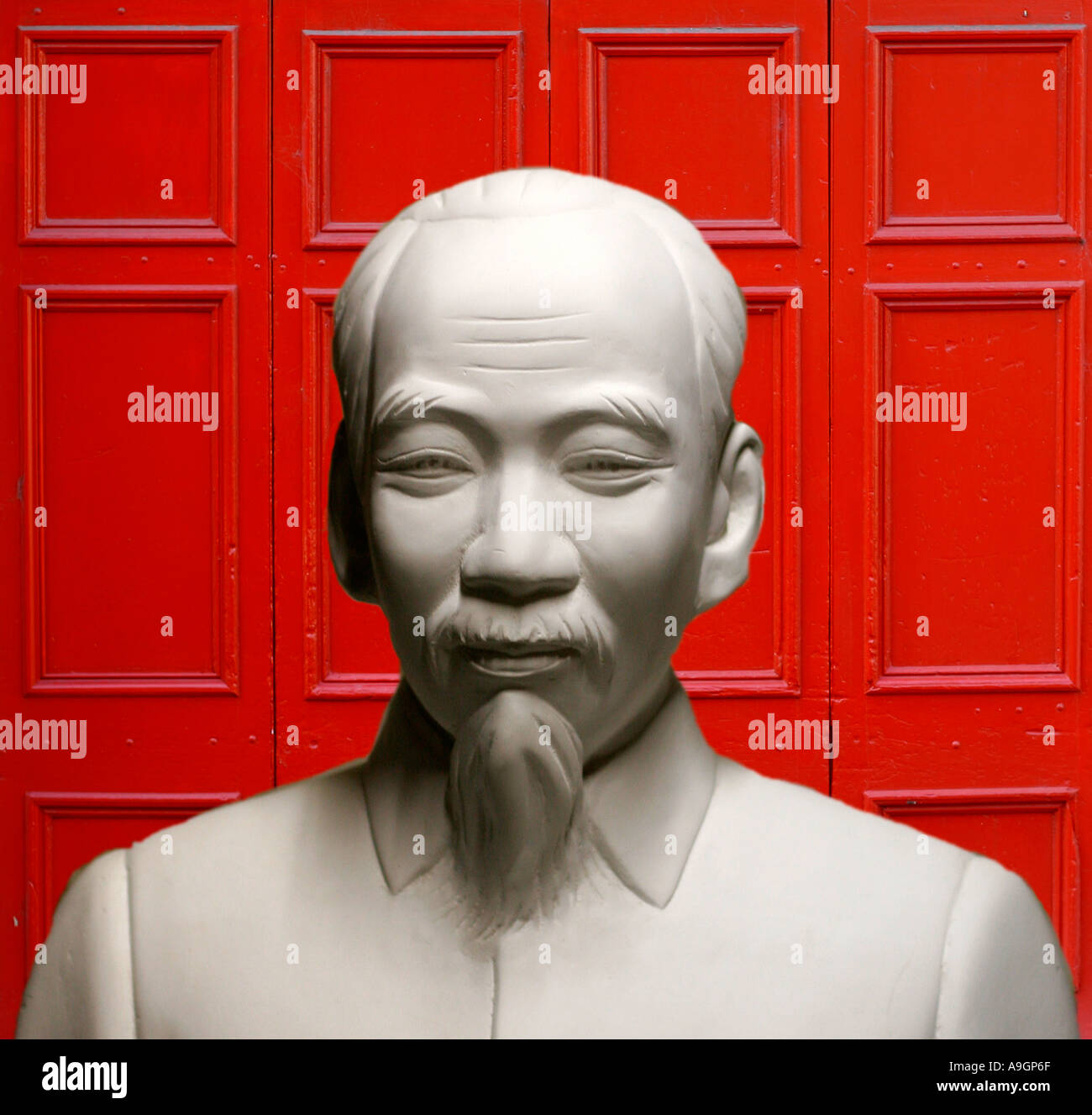 La sculpture classique de l'homme chinois avec la porte rouge comme symbole de la puissance chinoise. Banque D'Images
