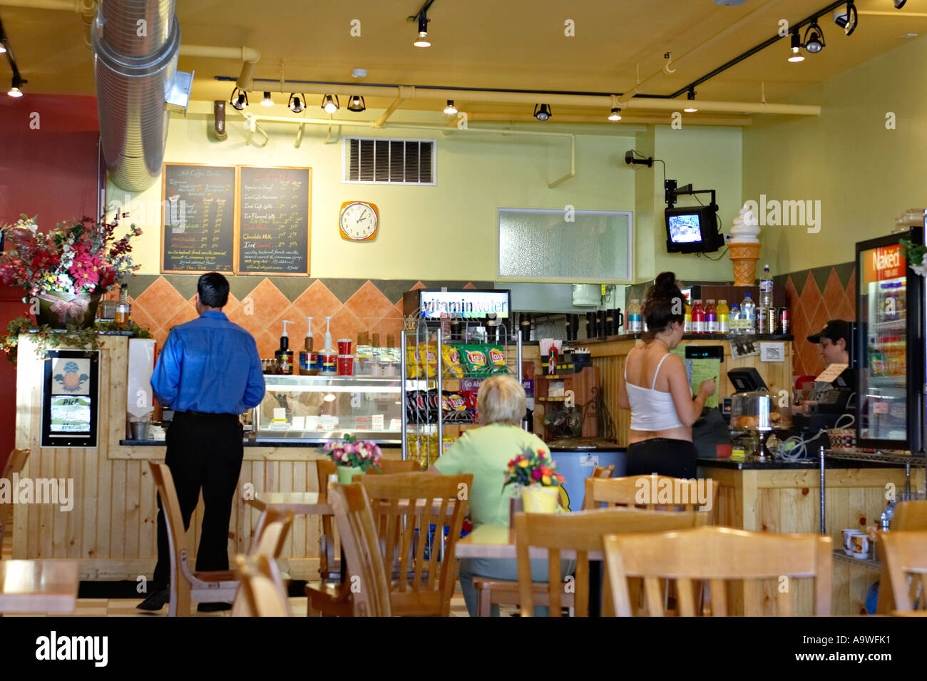 Chicago Illinois intérieur de petit café sur Division Street les clients attendent au comptoir femme plus assis à table en bois Banque D'Images