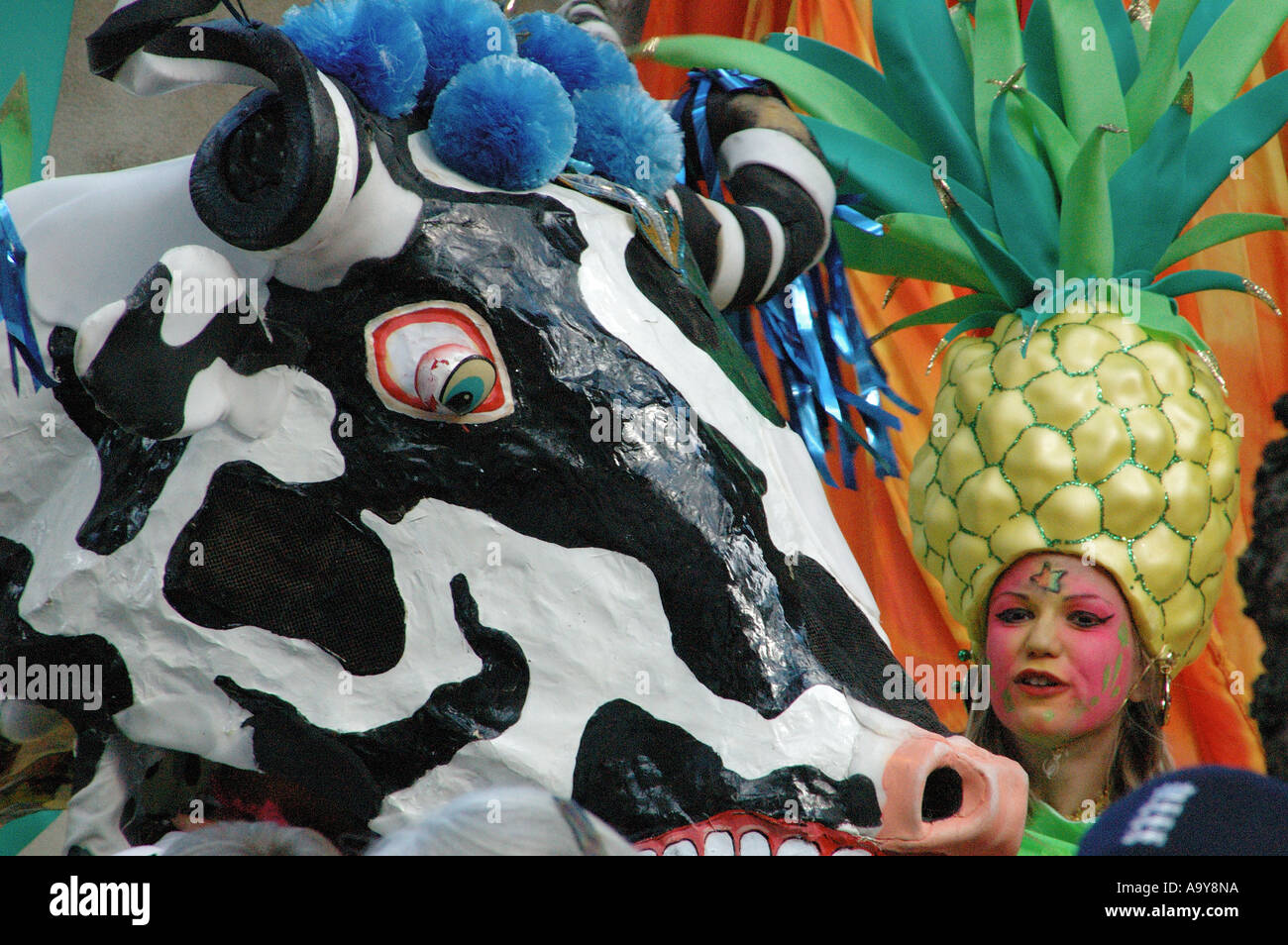 Fille avec une coiffure d'ananas nid permanent à un costume vache géante à la grande aspiration ouverture procession carnaval, Londres, UK Banque D'Images