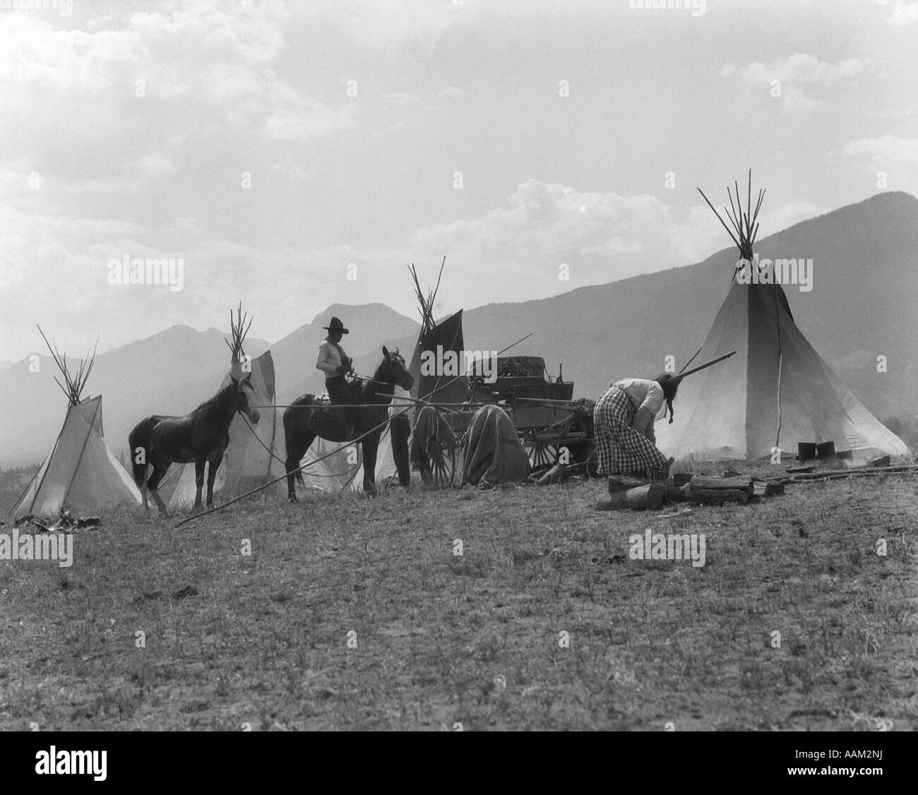 1930 NATIVE AMERICAN GROUPE DE CHEVAUX ET UN CHARIOT TIPIS campé dans une prairie de montagne en Colombie-Britannique CANADA Banque D'Images