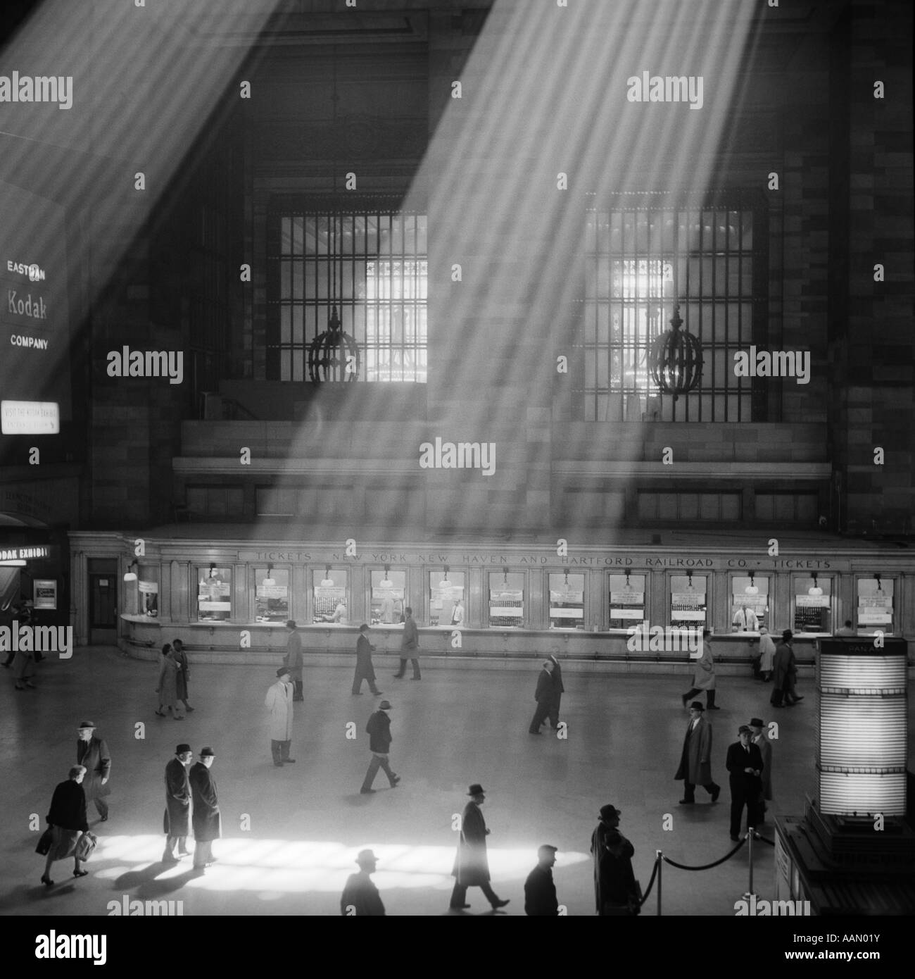 1960 Foule MARCHANT À TRAVERS LES RAYONS DANS LE MAGNIFIQUE ATRIUM CAVERNEUX POÉTIQUE DRAMATIQUE DE LA GARE GRAND CENTRAL NEW YORK CITY Banque D'Images