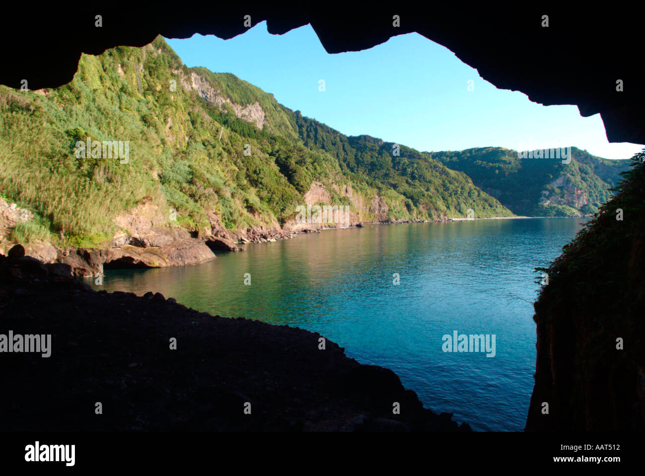 À la recherche d'une grotte dans une falaise dans une petite crique sur l'île de Flores aux Açores Banque D'Images