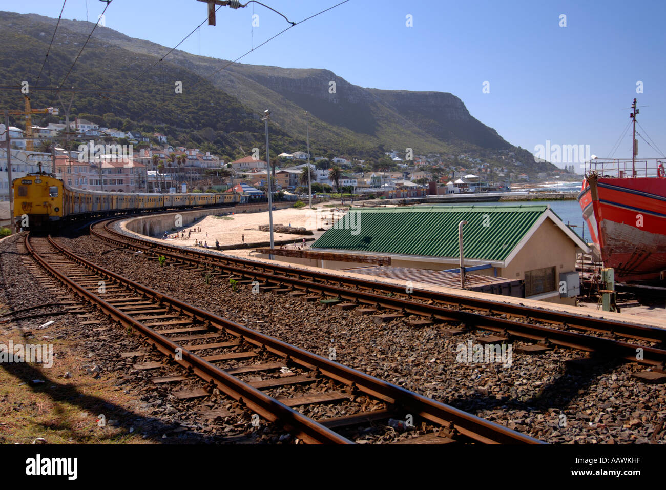 Un train en direction de passé sur le port de Kalk Bay Cape Town's littoral de l'océan Indien en Afrique du Sud. Banque D'Images