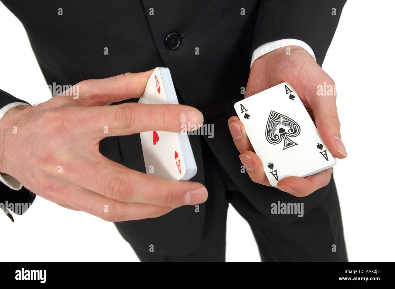 L'homme de couper un jeu de cartes montrant as de pique et l'as de coeur Banque D'Images