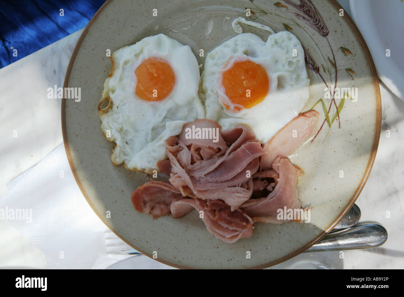 Une assiette avec des œufs et du bacon, à l'image d'un visage sur la plaque Banque D'Images