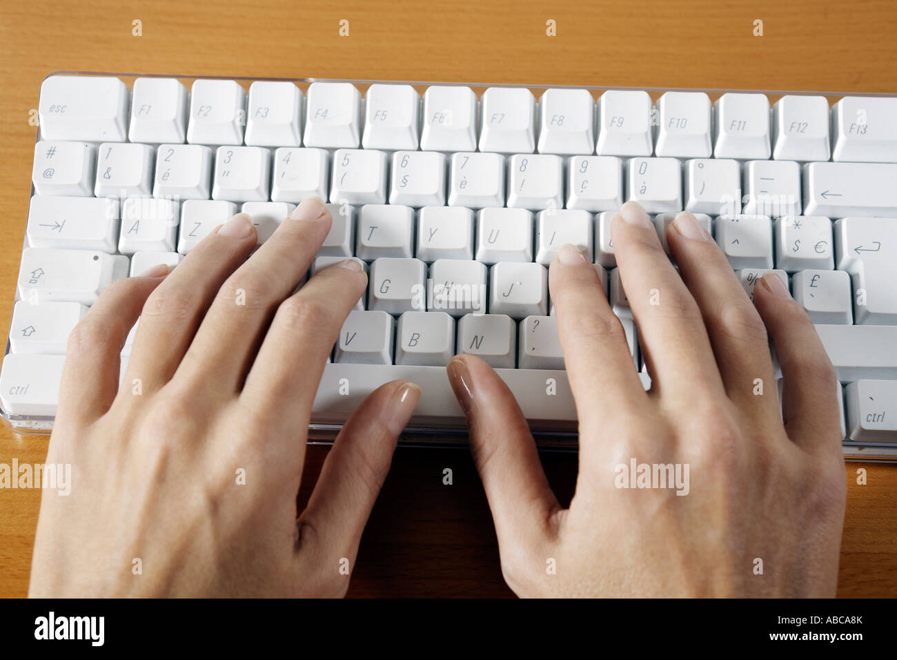 Part de la saisie sur un clavier blanc sans fil ordinateur posé sur table Banque D'Images