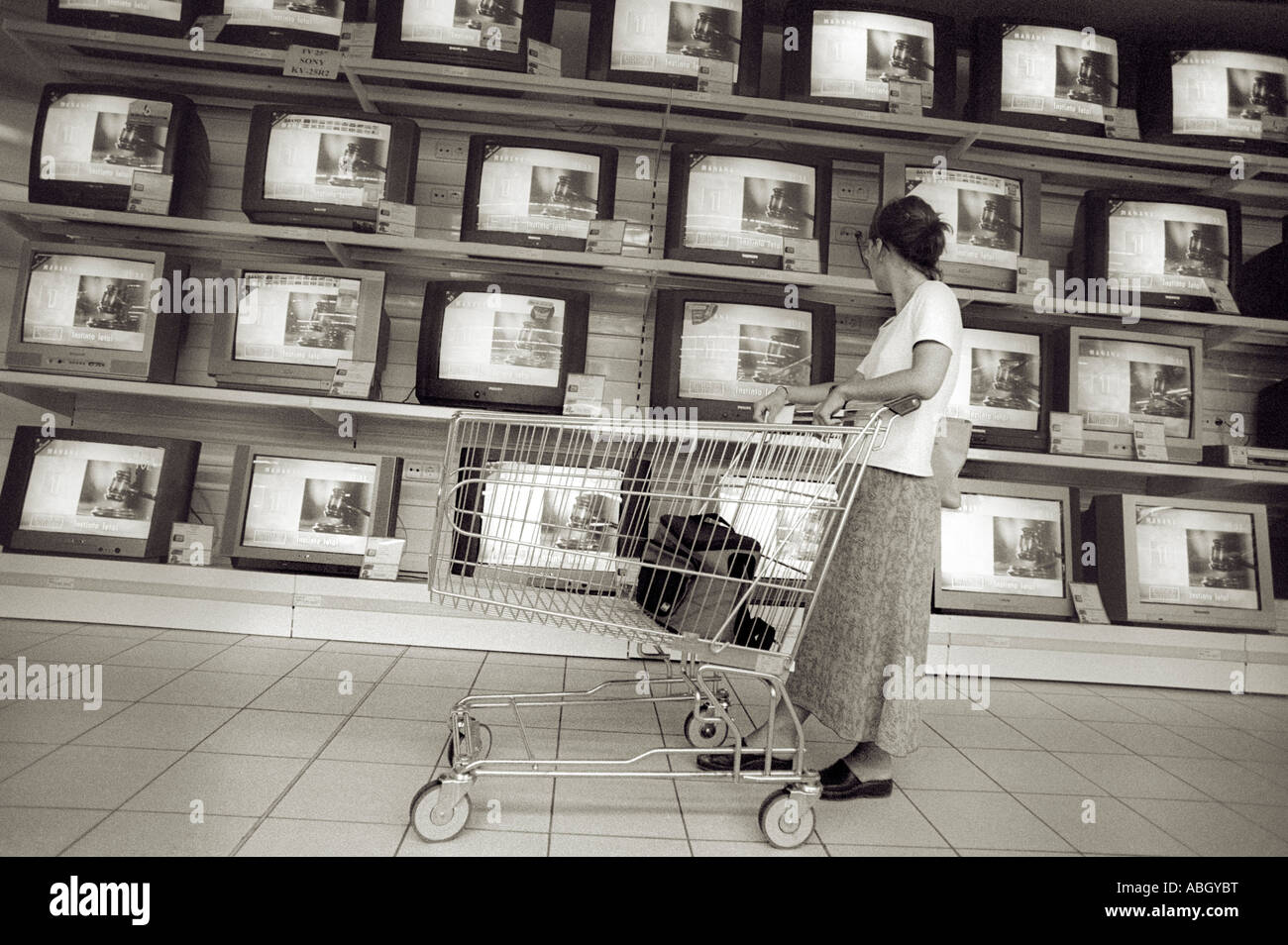 Les écrans de télévision en vente en supermarché AVEC UNE PERSONNE QUI REGARDE Banque D'Images