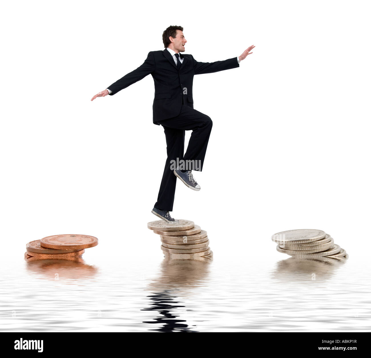 Man à travers des piles de pièces de l'équilibrage de votre argent Banque D'Images