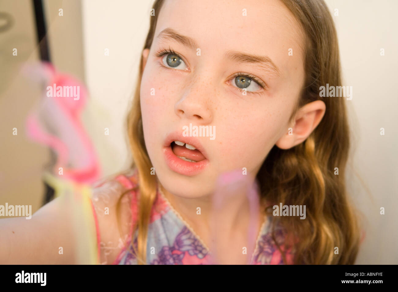 Portrait of Caucasian girl painting Banque D'Images