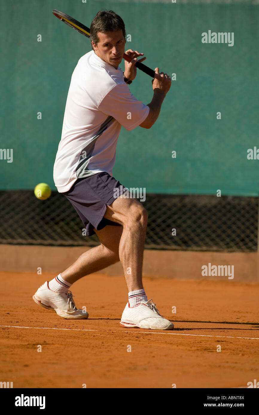Homme tennis player swinging Banque D'Images