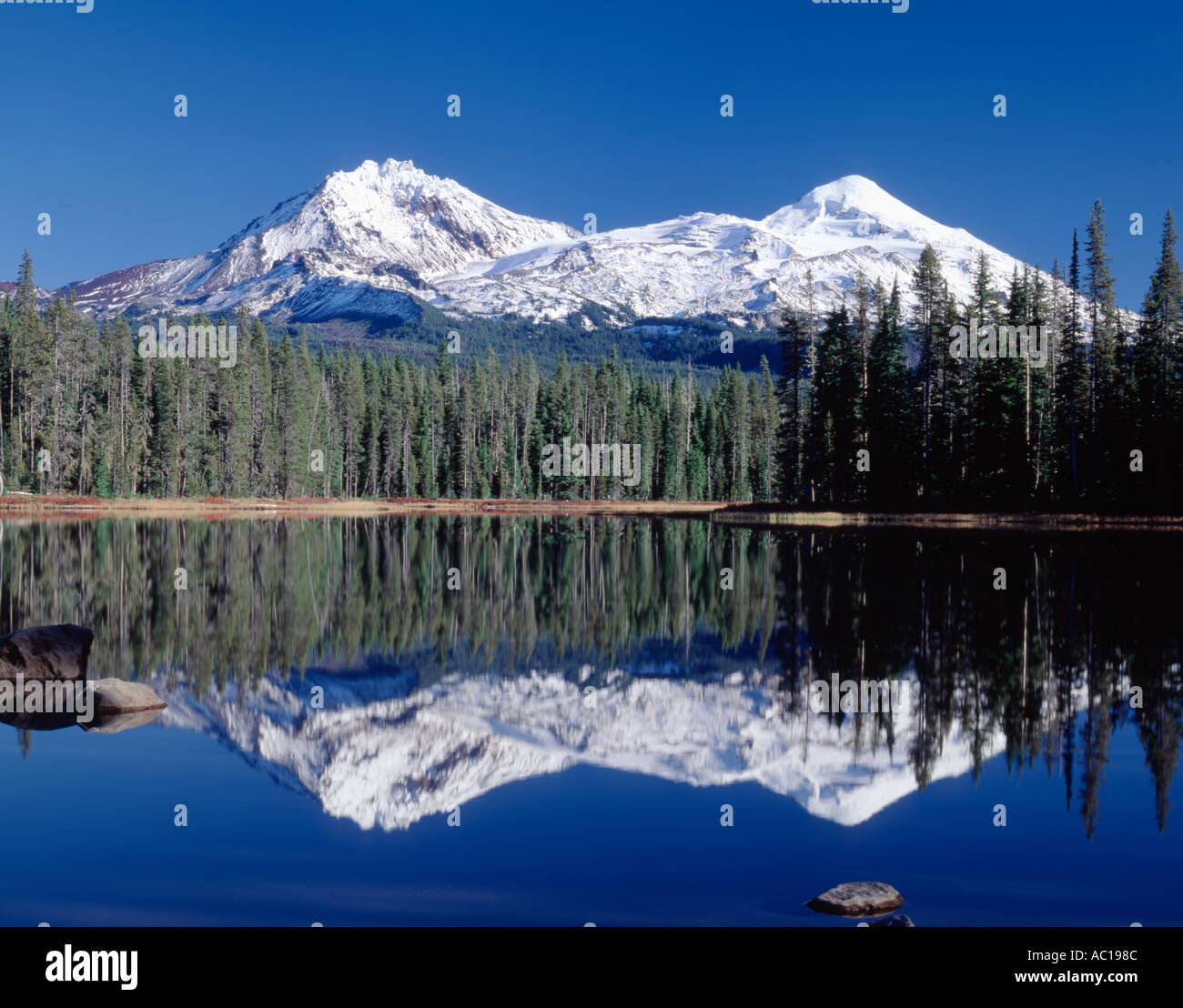 Scott Lake et de nouvelle neige sur le Nord et Moyen Soeur Montagnes de la chaîne des Cascades de l'Oregon Banque D'Images