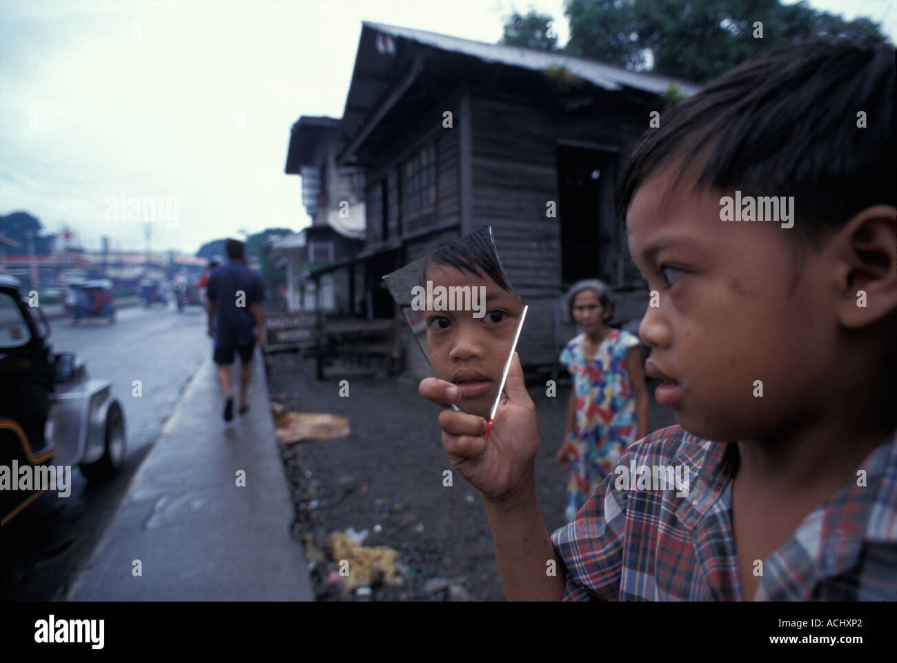 Philippines l'Île Panay Boy pairs en miroir brisé de la ville de Kalibo Banque D'Images