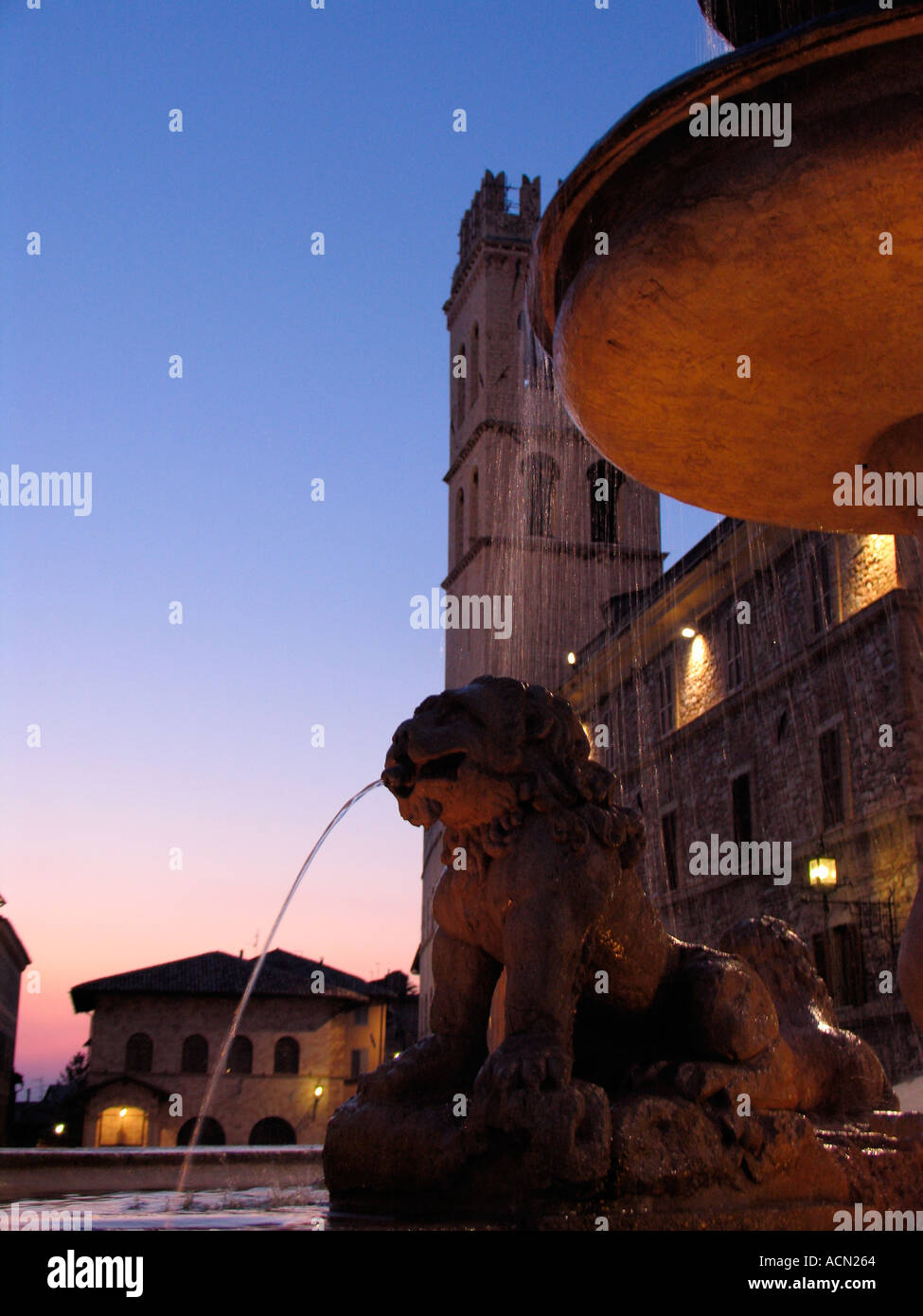 Fontaine de la Piazza del Comune avec le Temple Romain de Minerve et Torre del Popolo à l'arrière-plan Assisi Italie Banque D'Images