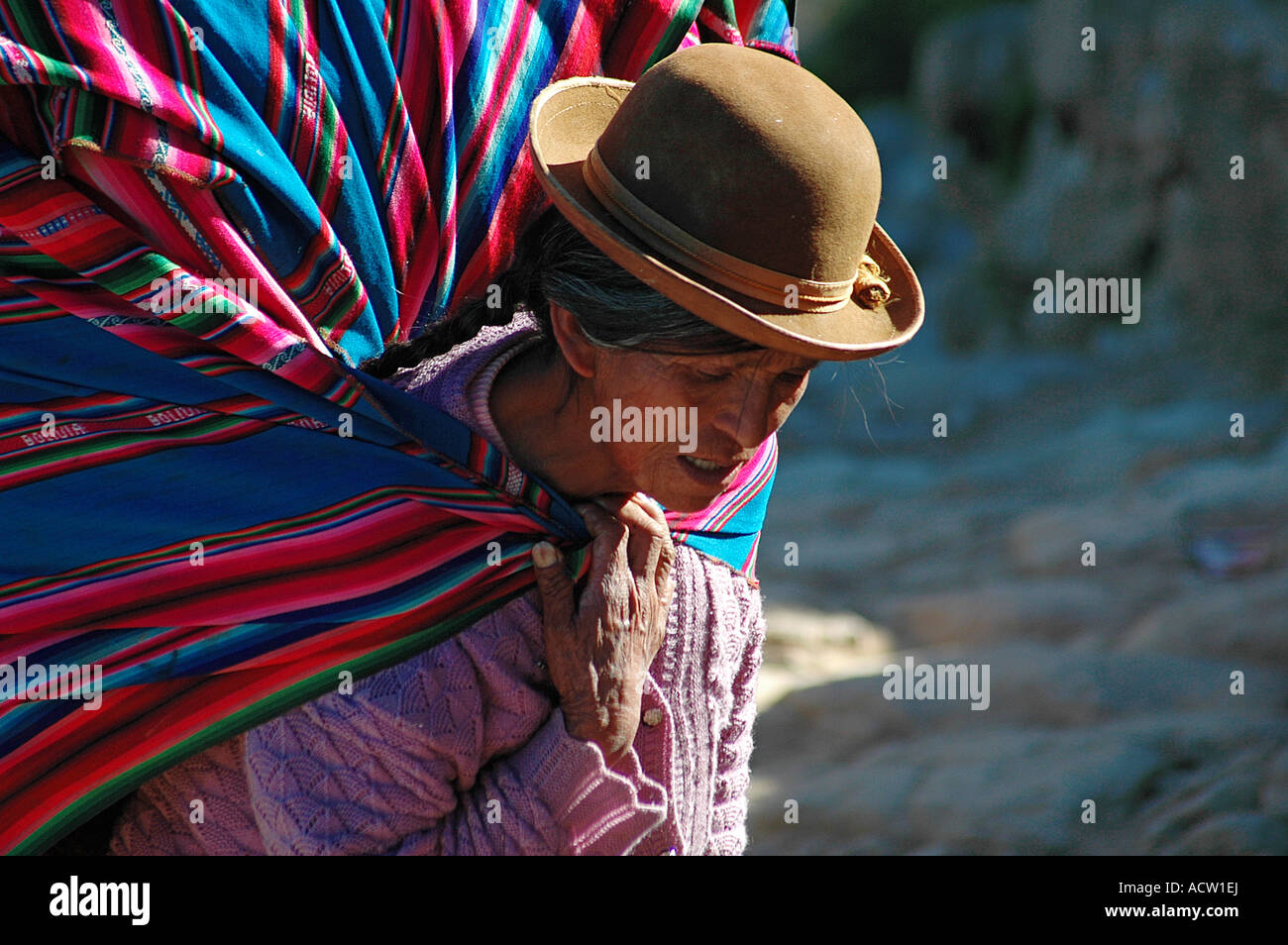 Femme bolivienne avec chapeau portant une grande charge sur ses épaules Banque D'Images
