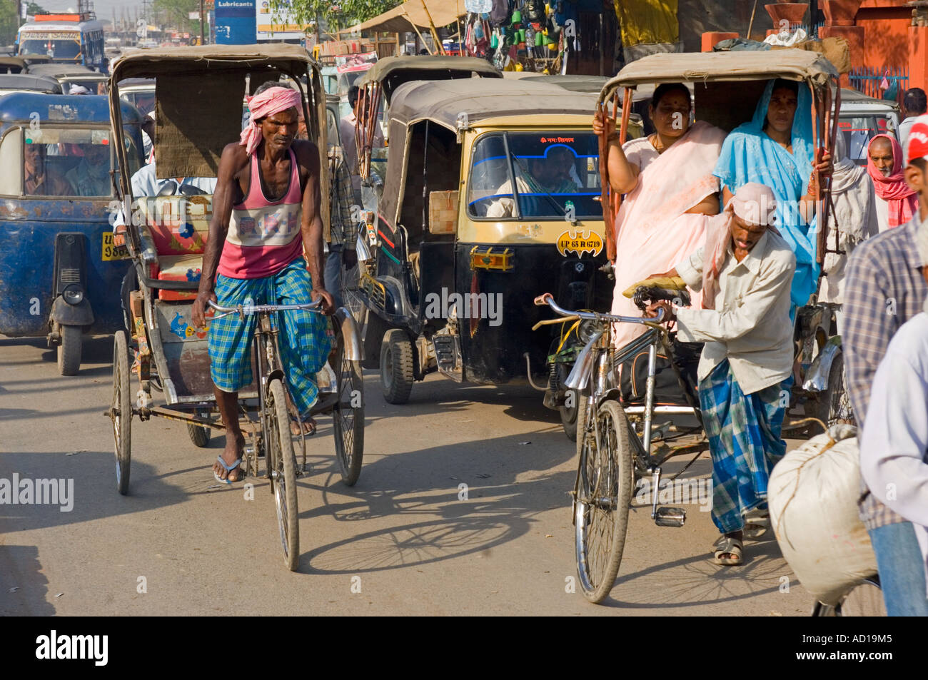 Une scène de rue chaotique typique à Varanasi avec randonnée et auto rickshaws (Tuk Tuks) sur les rues animées. Banque D'Images