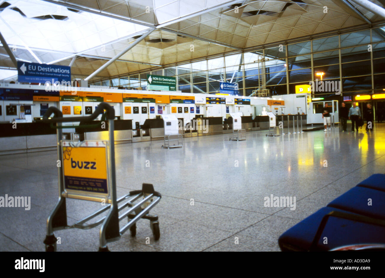 L'aéroport de Stansted vérifier dans la nuit vide à l'exception d'un seul chariot et quelques passagers Banque D'Images