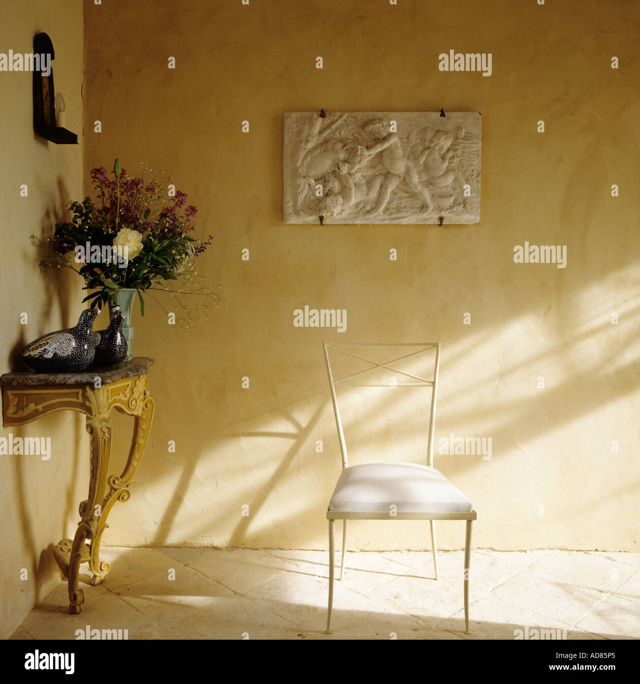 Coin chambre avec console doré table, chaise et bas-relief sur le mur de l'oeuvre Banque D'Images