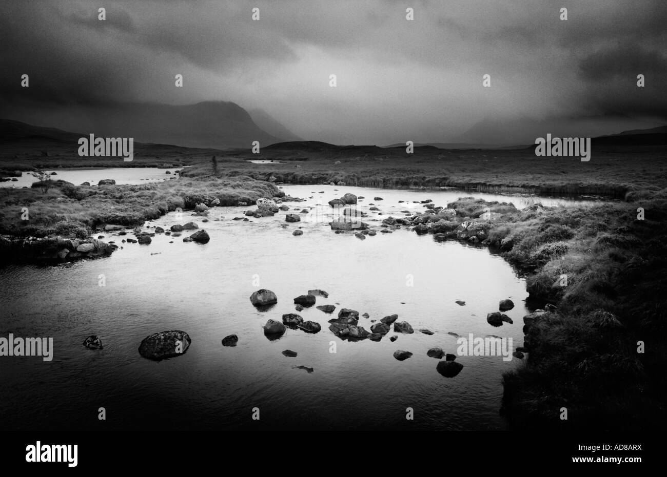 Vue sur Rannoch Moor dans les Highlands d'Ecosse montrant dramtic nuages et montagnes reflétée en noir et blanc Banque D'Images