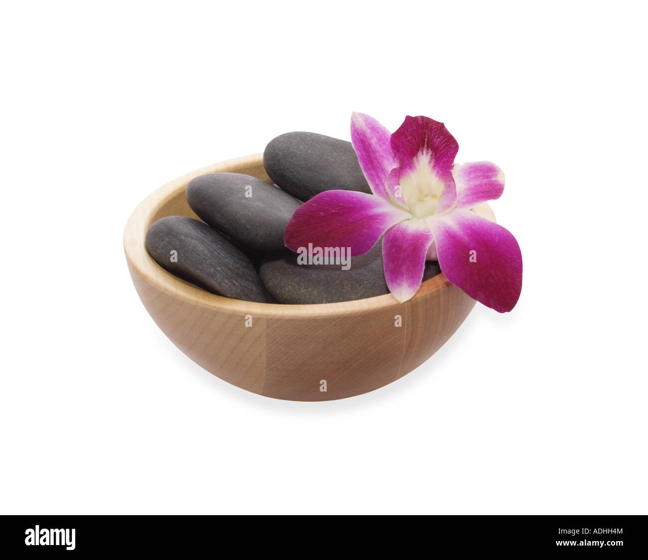 Orchid et cailloux noirs dans bol Banque D'Images