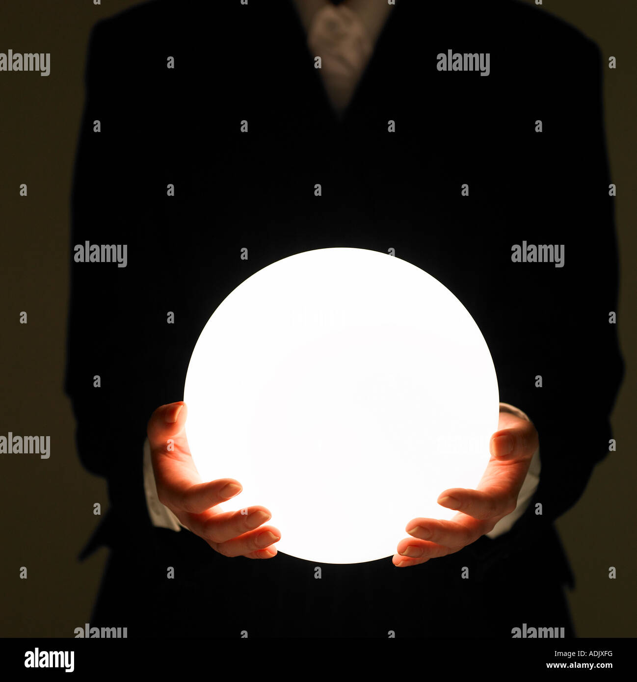 Un businessman holding a crystal bead Banque D'Images