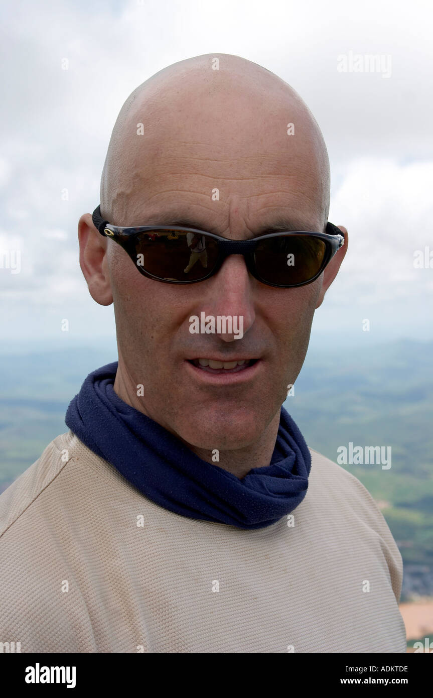 Homme avec tête rasée chauve et lunettes à la grave Photo Stock - Alamy