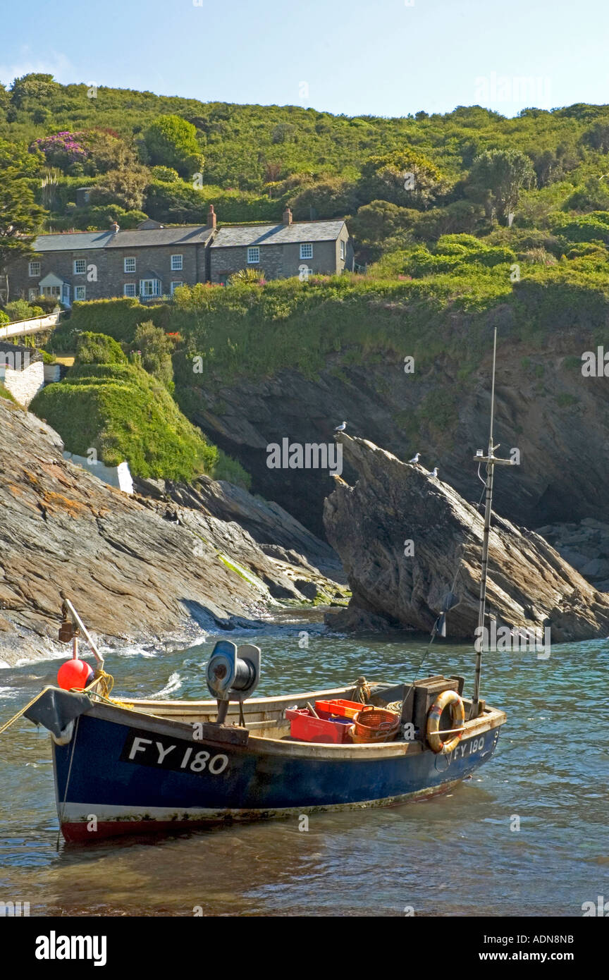 Un bateau de pêche amarré dans une crique tranquille à portloe à Cornwall, Angleterre Banque D'Images