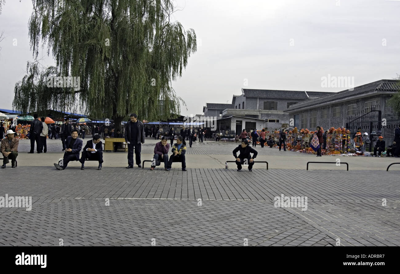 La CHINE XI'AN CHINOIS les hommes et les femmes en attente de l'autobus à l'extérieur du musée des guerriers en terre cuite à Xi'an Banque D'Images