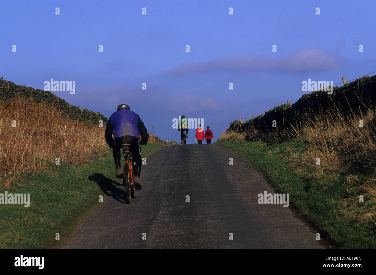 Les cyclistes et randonneurs, Peak District National Park, sur la route de Rendeux, près de Bakewell, Derbyshire, Royaume-Uni. Banque D'Images