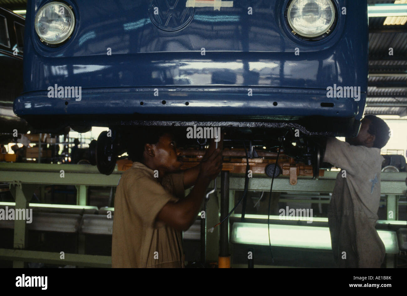 L'Afrique de l'Ouest Nigeria Lagos Hommes travaillant sur la partie inférieure de la voiture sur la ligne de montage automobile Volkswagen VW Banque D'Images