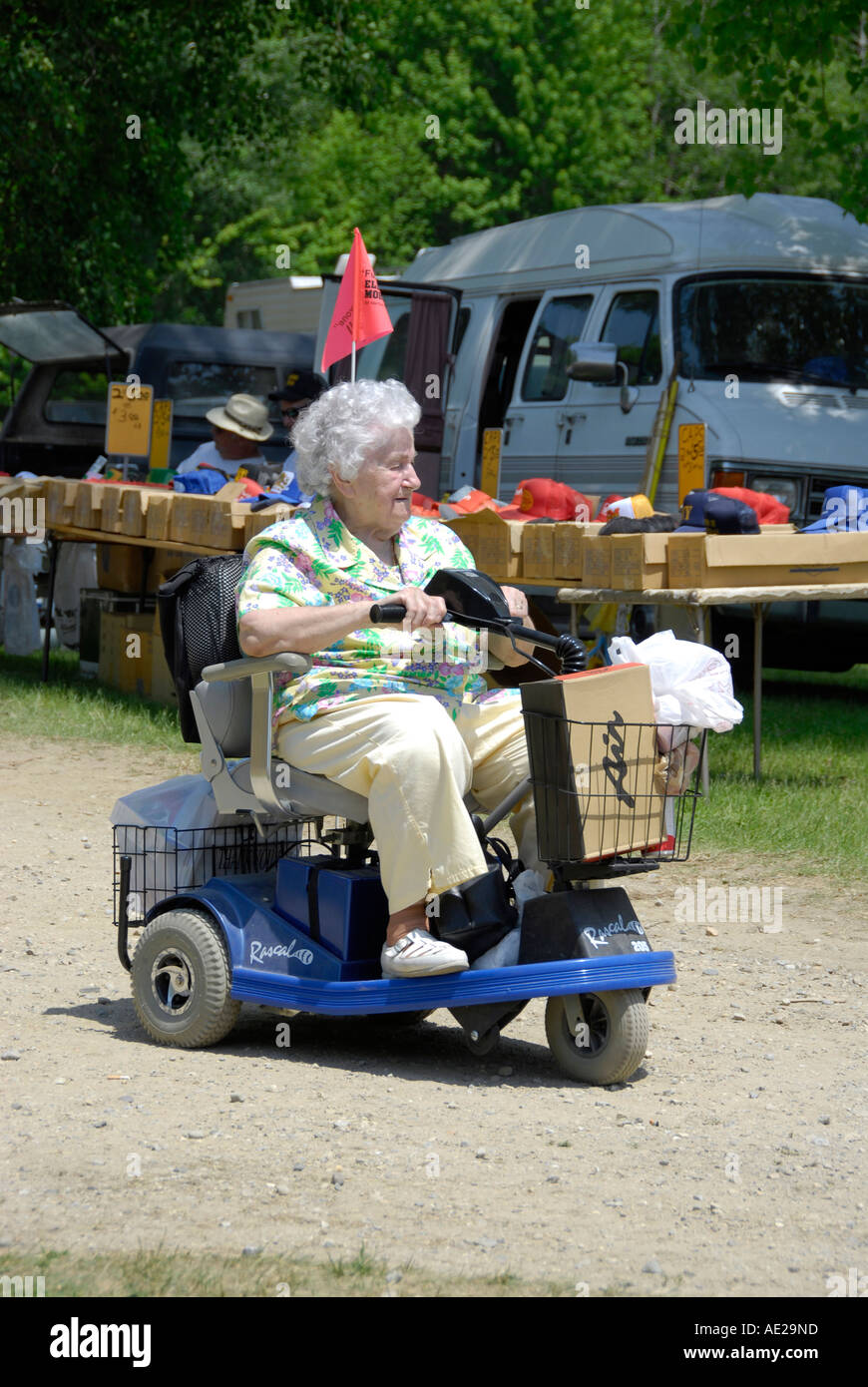 Senior female obtient autour sur un fauteuil roulant motorisé. Banque D'Images