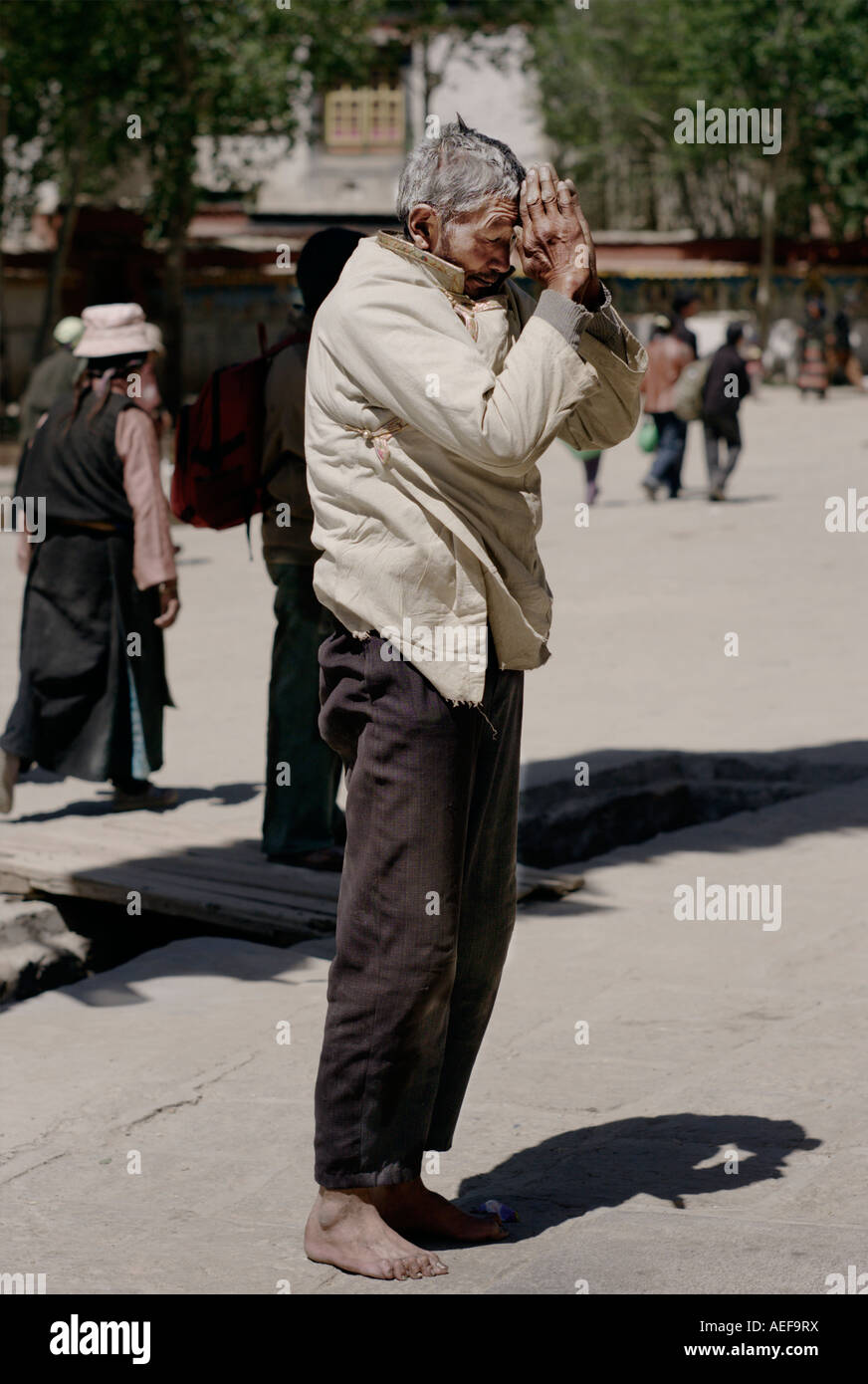 Vieil homme priant au monastère de Pelkor Chode Banque D'Images