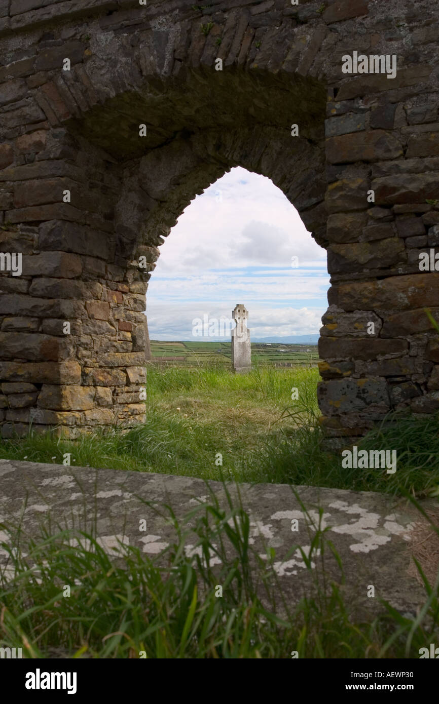 Cimetière abandonné chistian croix celtique à l'ouest du comté de Clare, pierre tombale vue par archway Banque D'Images