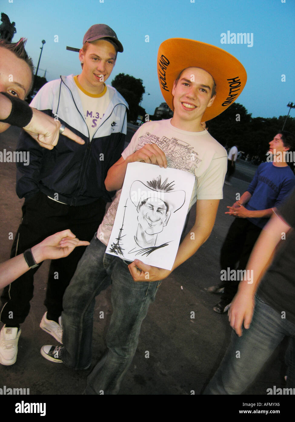Étudiant néerlandais avec ses amis montrant outre de caricature réalisée par l'artiste de rue, Paris France Banque D'Images