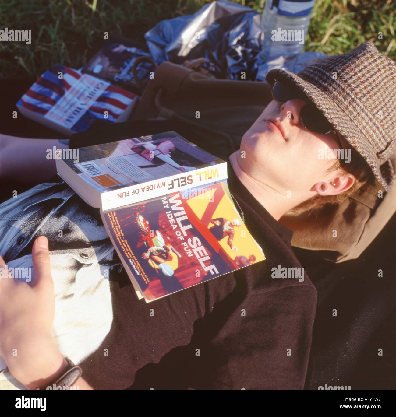 Un homme endormi pendant la lecture d'un livre s'auto au Hay Festival, Hay-on-Wye, au Pays de Galles, Royaume-Uni Banque D'Images