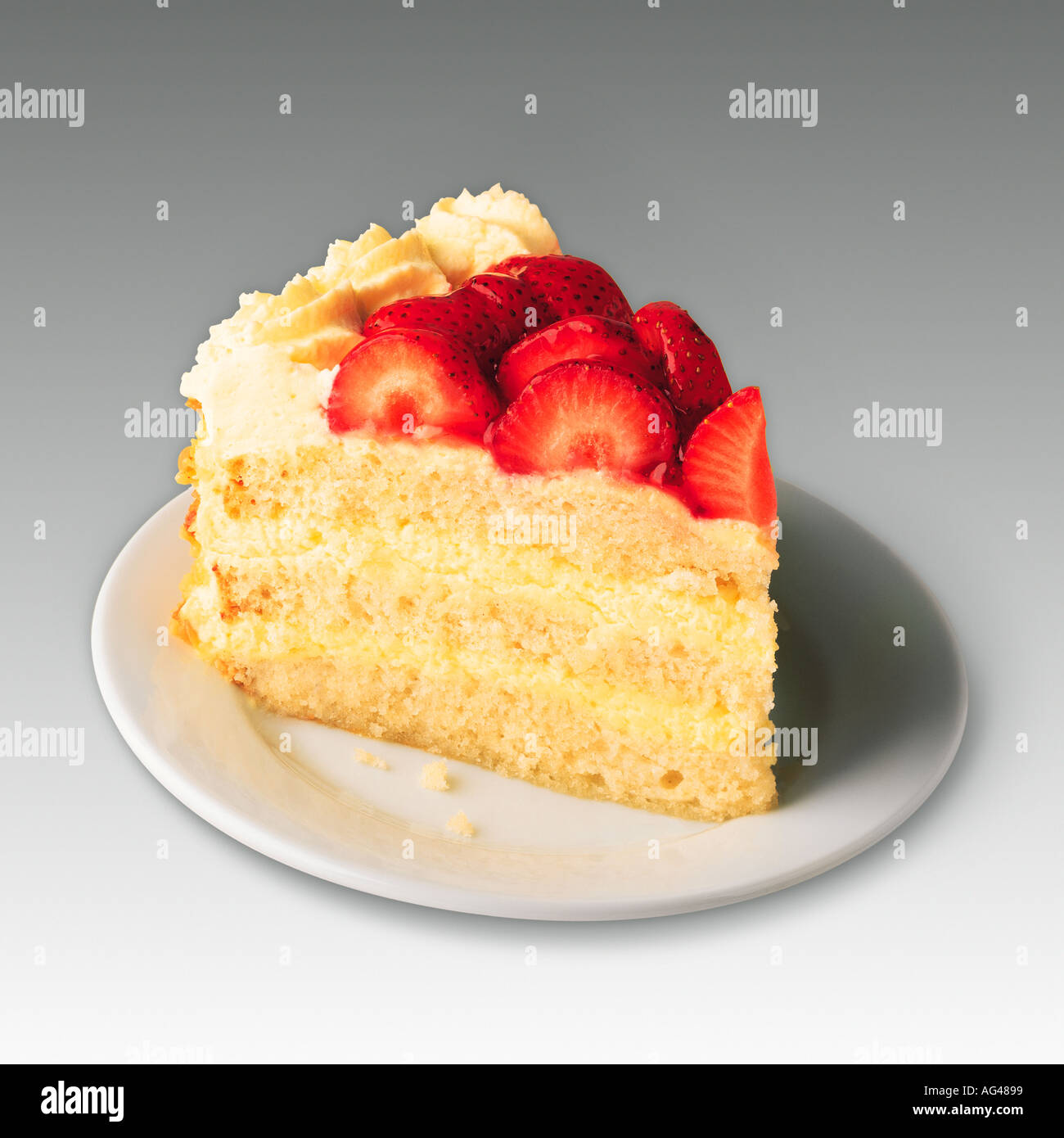 Morceau de gâteau. Gâteau de couche éponge Victoria aux fraises et à la crème sur une plaque blanche. Studio toujours la vie simple arrière-plan. Banque D'Images