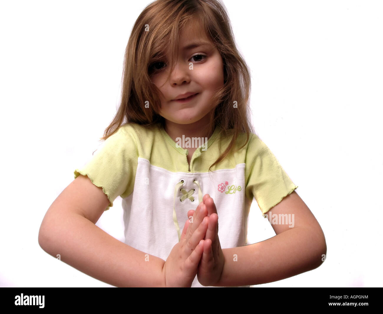 Une petite fille la main pour prier. Banque D'Images