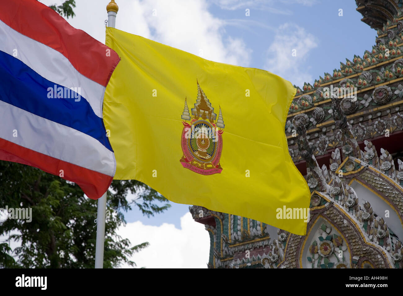Drapeau jaune du roi Bhumibol Adulyadej de Thaïlande vole à Wat Pho à Bangkok, Thaïlande, à côté du drapeau thaïlandais rouge bleu et blanc. Banque D'Images