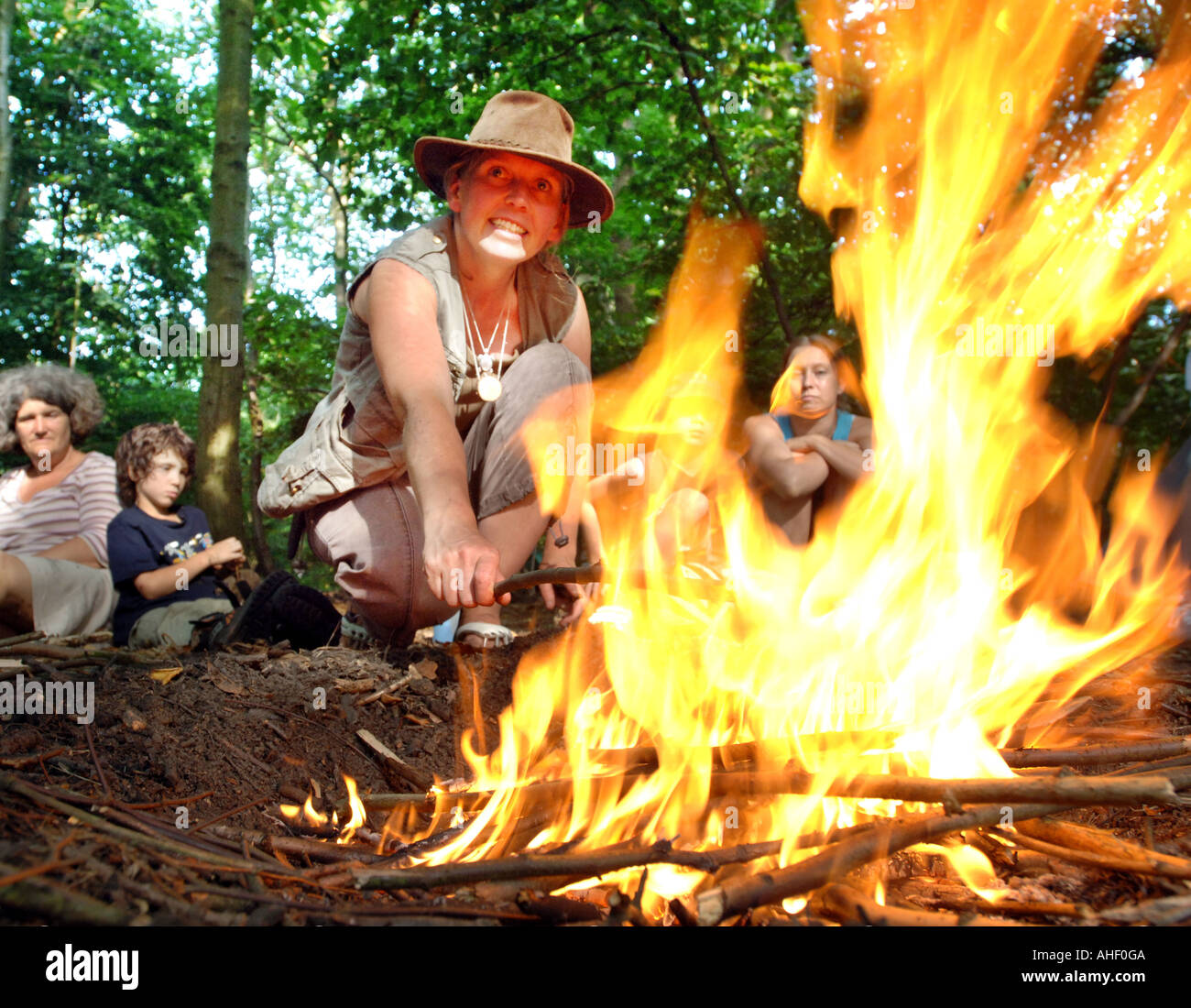 Expert en milieu sauvage femme montre comment allumer un feu de camp. Banque D'Images