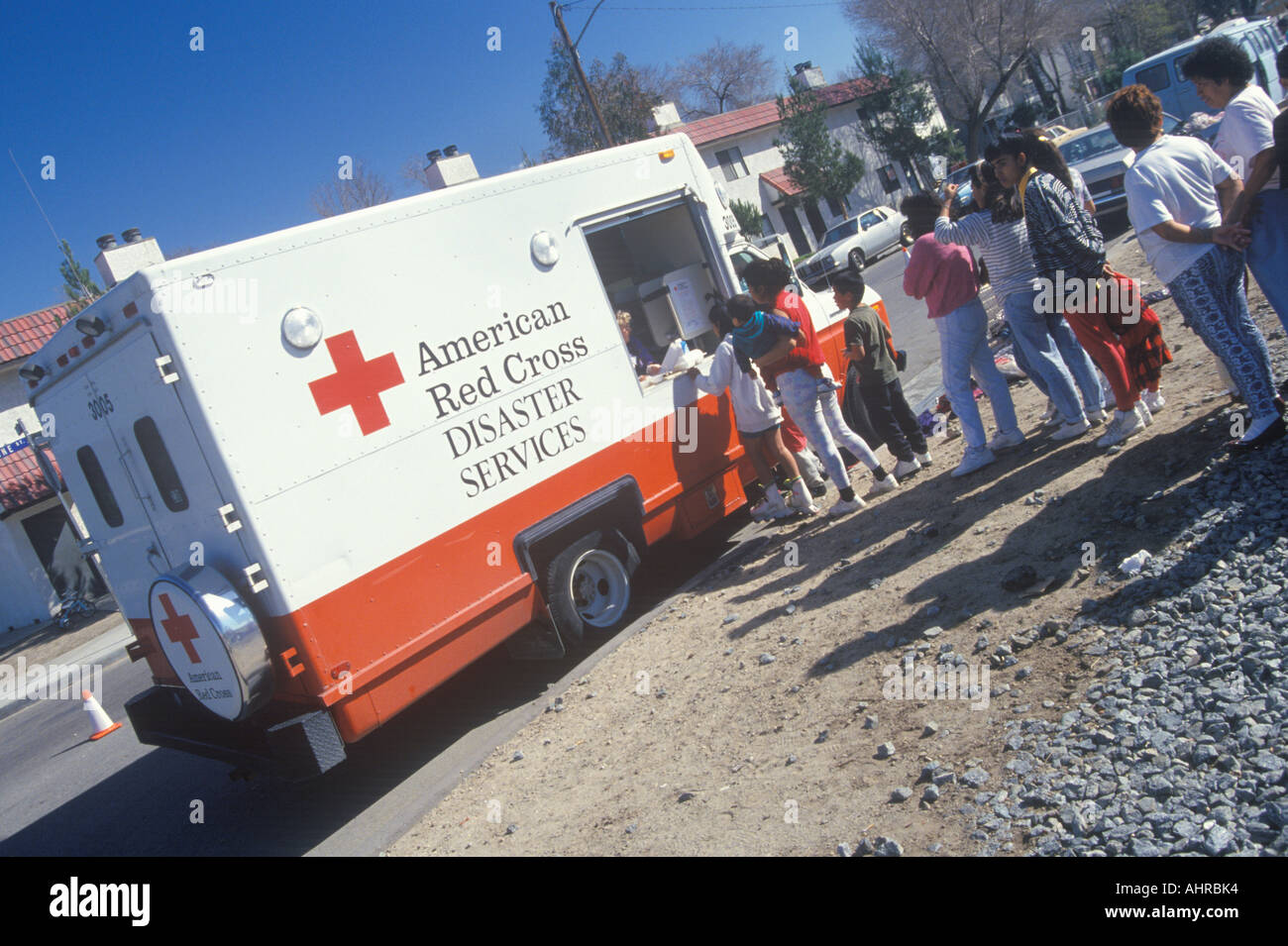 Un travailleur dans un service d'urgence de la Croix-Rouge américaine véhicule distribuant des fournitures aux personnes après le séisme de 1994 Banque D'Images