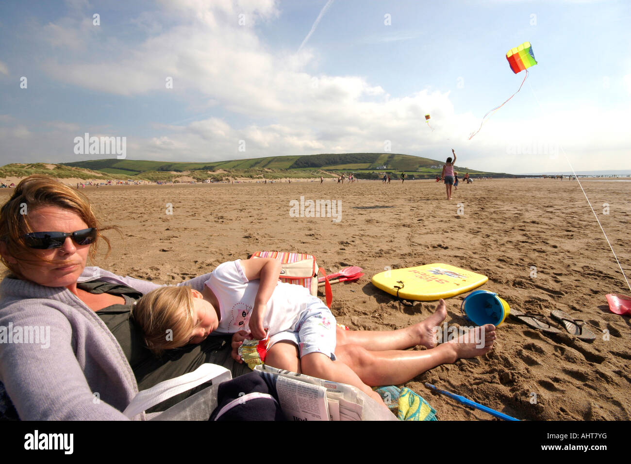 Femme et fille assis sur un cerf-volant de plage Devon UK Banque D'Images