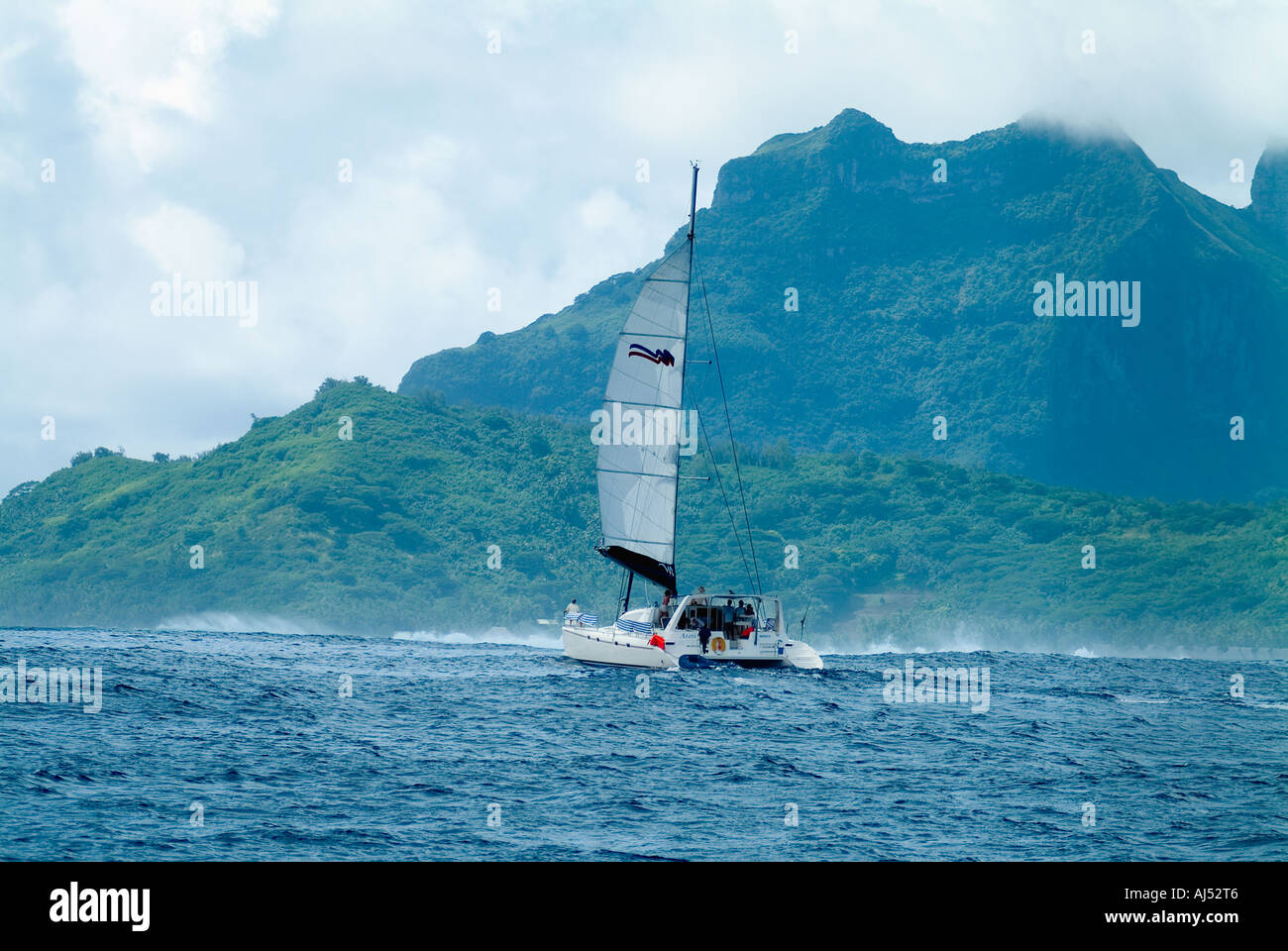 Catamaran à charte entrant Taha'a Lagoon Reef Pass, Polynésie Française Banque D'Images
