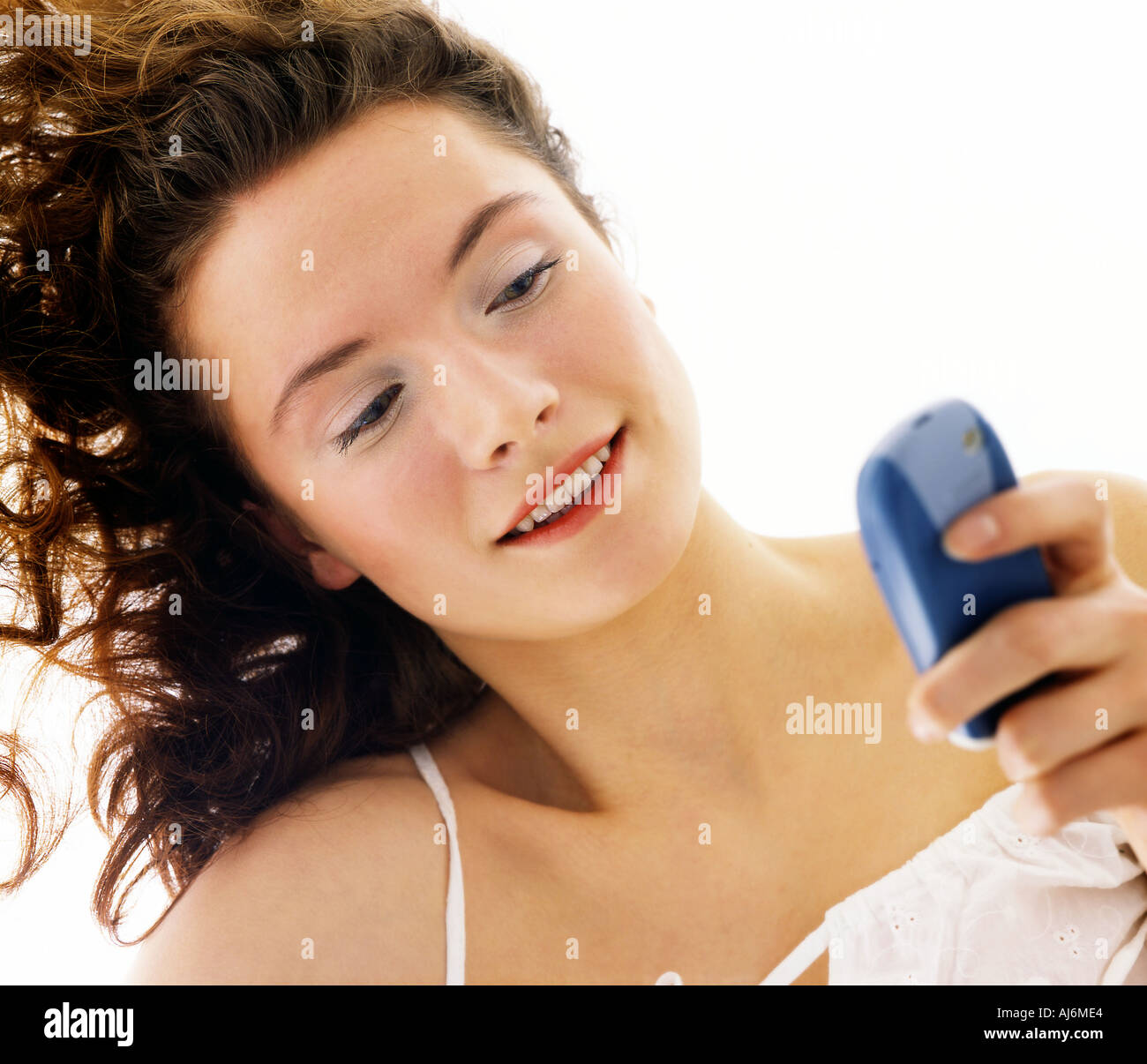 Femme à l'aide de son téléphone et se trouvant sur le plancher. Banque D'Images