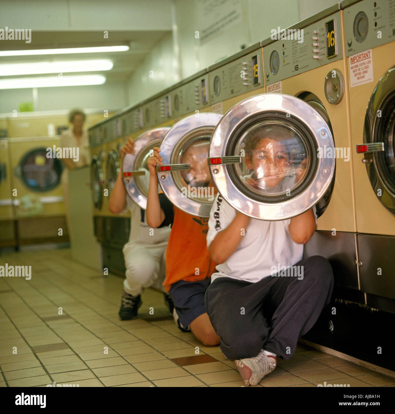 Amusant drôle humour bande dessinée libre des enfants dans une laverie  automatique à la recherche à travers les portes en verre de machines à laver,  HXXZsmng Photo Stock - Alamy